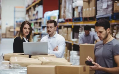 portrait-smiling-warehouse-managers-using-laptop_107420-13560